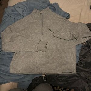 Quarter zip grey cropped sweatshirt w/adjustable drawstring at the waist